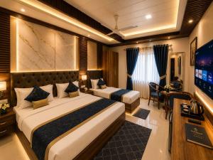 a hotel room with two beds and a flat screen tv at Hotel Montanaa Plaza Near Delhi Airport - Free Airport Pickup & Drop and Breakfast- Dinner complementary in New Delhi