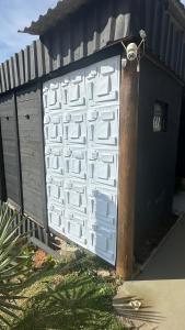 a white garage door on the side of a house at Front in Domingos Martins +5 photos