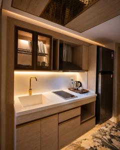 a kitchen with a sink and a refrigerator at Flamingo Cairo Airport Hotel & Free Airport Pickup in Cairo