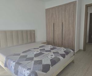 a bedroom with a bed and a wooden cabinet at rental per night in Nabeul +16 photos