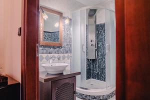 a bathroom with a sink and a shower at Palea Poli Boutique Hotel in Naousa +82 photos