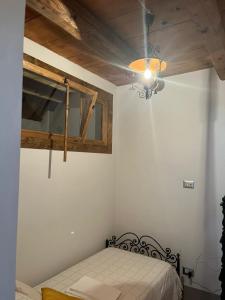 a bedroom with a bed and a ceiling fan at Il Convento di Laura in Civitanova del Sannio