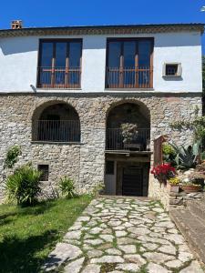 a stone house with windows and a driveway at Il Convento di Laura in Civitanova del Sannio +11 photos