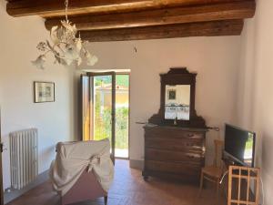 a living room with a dresser and a television at Il Convento di Laura in Civitanova del Sannio