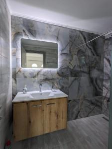 a bathroom with a sink and a mirror at Harmony Sunset in Skala Sotiros