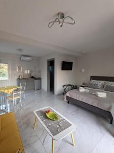 a bedroom with a bed and a table with a bowl of fruit at Harmony Sunset in Skala Sotiros +18 photos