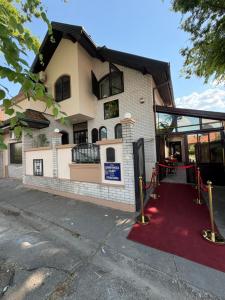a building with a red carpet in front of it at Balkan 024 in Subotica