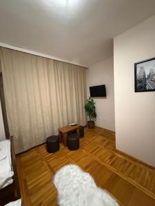 a living room with a couch and a table at Balkan 024 in Subotica +6 photos