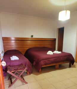 a bedroom with two beds with towels on them at Patio Prana Apart Resto in Federación
