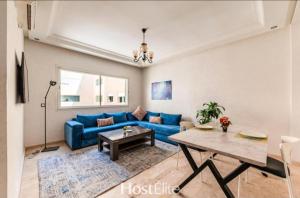 a living room with a blue couch and a table at Central Park in Mohammedia
