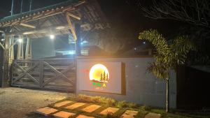 a sign in front of a building at night at Avocado in Domingos Martins