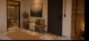 a room with a door and a bench with pillows at Avocado in Domingos Martins