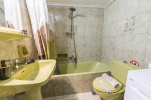 a bathroom with a sink and a toilet and a tub at Varkiza Beach Summerhouse-Athens Riviera in Vari +35 photos