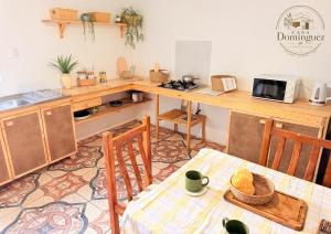 a kitchen with a table and chairs and a counter top at Taltal - Casa Dominguez in Taltal