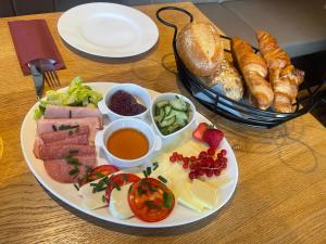 a plate of food with meat and vegetables and bread at Alpenstube Ockholm in Ockholm +3 photos