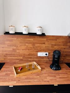 a room with a wooden floor with a table at Le Comptoir du Relais in Beine