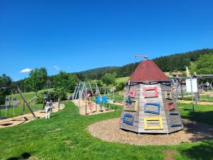a playground with a play structure in a park at Bergzauber Bayerwald - voll ausgestattetes Familienapartment mit Pool in Sankt Englmar