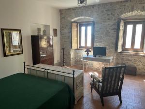a bedroom with a bed and a desk and a chair at Il Convento di Frida in Civitanova del Sannio +9 photos