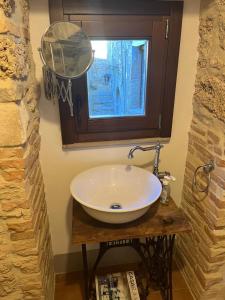 a bathroom with a sink with a mirror and a window at Il Convento di Frida in Civitanova del Sannio