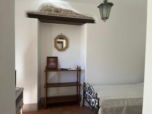 a bedroom with a bed and a mirror on the wall at Il Convento di Frida in Civitanova del Sannio