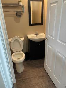 a bathroom with a toilet and a sink at Timber Wolf Inn Motel in Nipigon