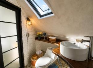 a bathroom with a white sink and a window at Hichata Breakfast Included in La Calera