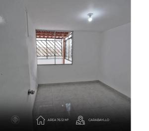 a room with a window and a white wall at Torre in Carabayllo +1 photo