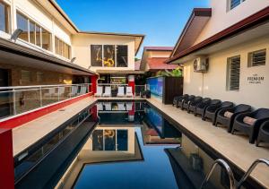 a house with a swimming pool with chairs in it at L'Eskale Guyane in Montjoly