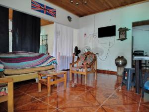 a living room with a bed and a couch and a table at Riveras Del Magdalena in Honda