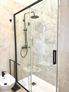 a shower in a bathroom with a glass shower backdoor at Xenia Suites Duomo in Reggio di Calabria +35 photos