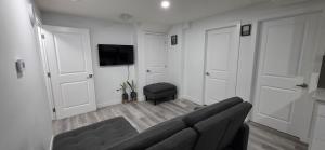 a living room with a couch and a chair at Entire guest basement suite in Cochrane, AB in Cochrane