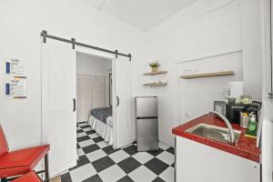 a small kitchen with a sink and a refrigerator at LISBD7D - JL Condado in San Juan