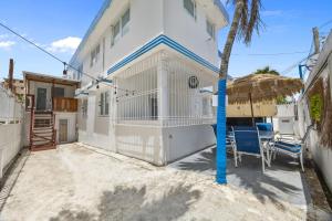 a white house with a palm tree in front of it at LISBD7D - JL Condado in San Juan