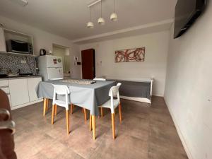 a kitchen with a table and chairs in a room at Emma in Villa Carlos Paz