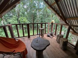 a dog laying on a deck in a cabin at Entire Jungle Chalet Playa Ganadito in Drake