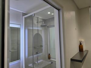 a glass shower in a bathroom with a sink at Kingsley at 1 on Albert in Cape Town +12 photos