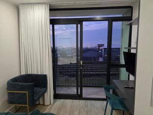a room with a chair and a window with a view at Kingsley at 1 on Albert in Cape Town