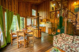 a living room with a table and a kitchen at Patagonia Mawida in Neltume