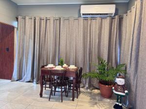 a dining room table and chairs in a room with curtains at Yalala Jacuzzi in Jabillos