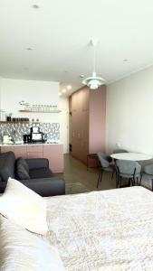 a bedroom with a bed and a living room and a table at Go Bamboo Beach Apartments in Ts'ikhisdziri