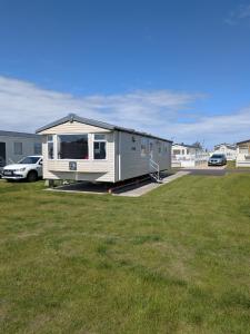 a mobile home is parked in a parking lot at 69 Lighthouse View, Silver Sands Holiday Park in Lossiemouth