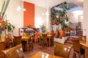 a restaurant with tables and chairs and a fireplace at Hotel Casa Deco in Bogotá