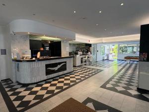 a large kitchen with a checkerboard floor at Hotel Soraya & Apartments in Lignano Sabbiadoro +90 photos