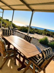 a wooden table and chairs on a patio at Explorers Roost in Kalbarri