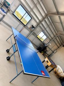 a large blue table in a room with windows at Explorers Roost in Kalbarri +1 photo