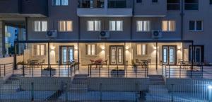 a building with a balcony with tables and chairs in front of it at D'stay by Dastid in Golem
