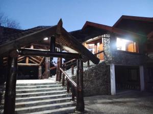 a set of stairs in front of a building at Aurum patagonia hotel in Lago Puelo