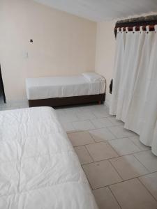 a bedroom with a mattress and a bed and curtains at Aurum patagonia hotel in Lago Puelo +7 photos