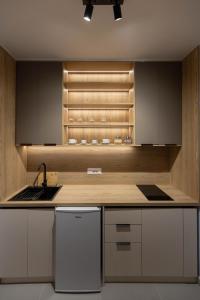 a kitchen with a sink and a refrigerator at D'stay by Dastid in Golem