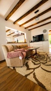 a living room with a couch and a table at Apaurin Lodge - Peacful Nature Escape near Bosnian Pyramids in Visoko